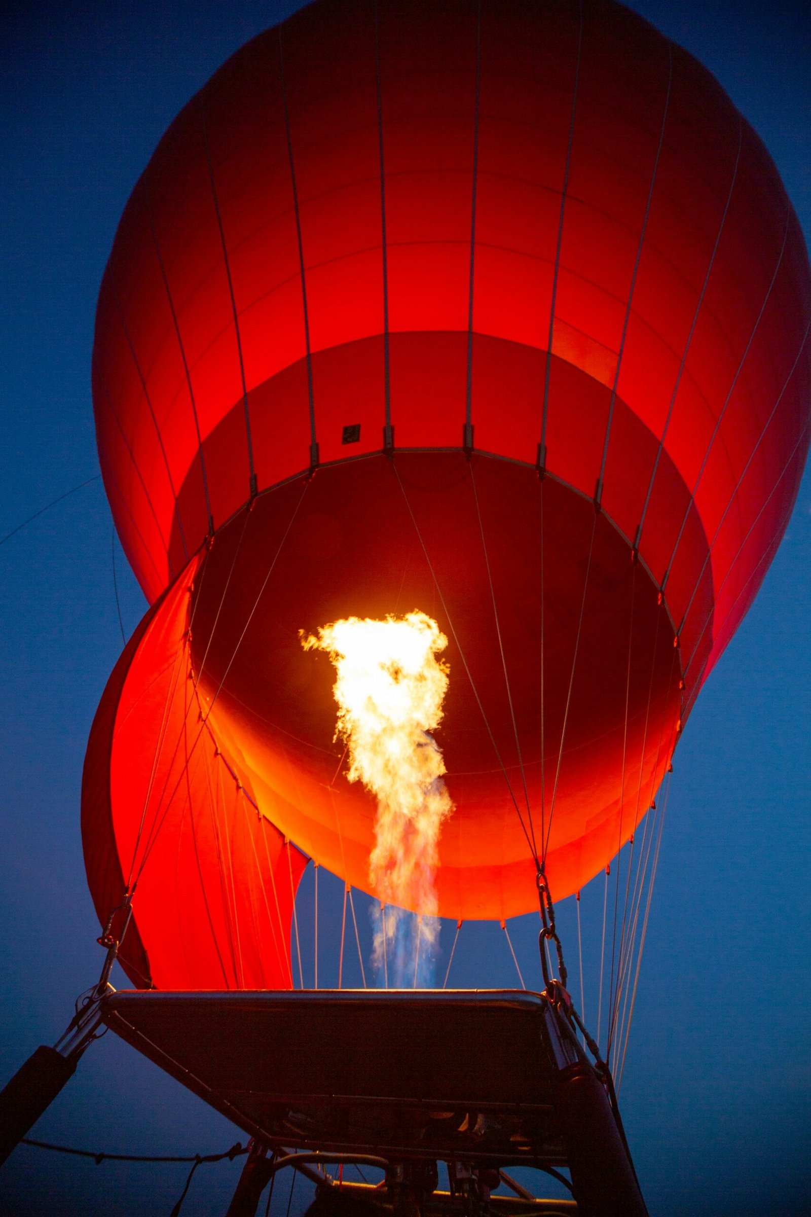A hot air balloon inflating over the desert of Marrakech at sunrise, Atlas Mountains in the background